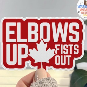 Puede incluir: Pegatina roja y blanca con el texto "Elbows Up Fists Out" y una hoja de arce canadiense en el centro.