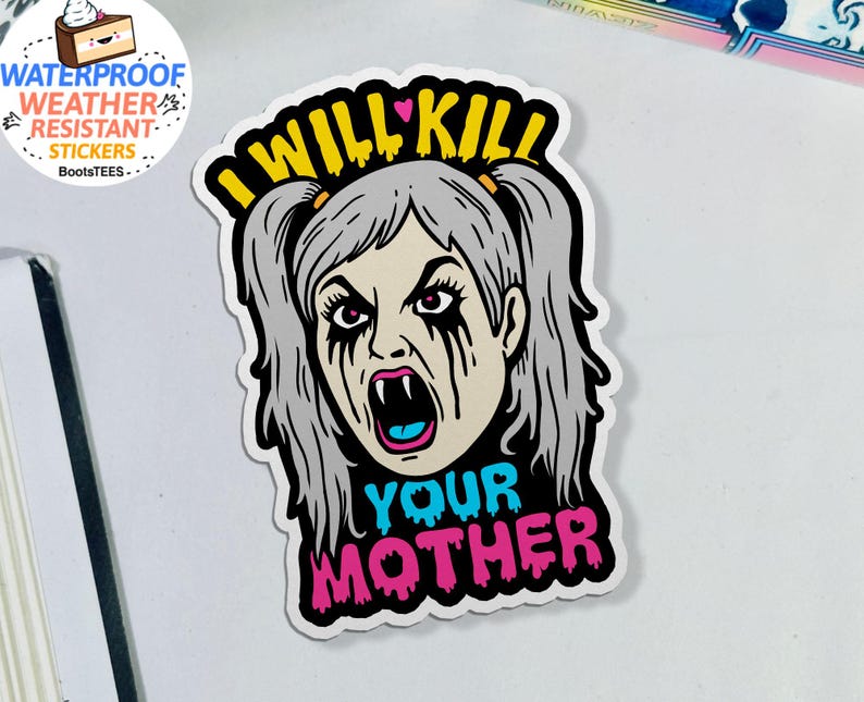 May include: A white sticker featuring a cartoon illustration of a woman with gray hair, fangs, and black tears. The text "I WILL KILL YOUR MOTHER" is written in yellow, blue, and pink.