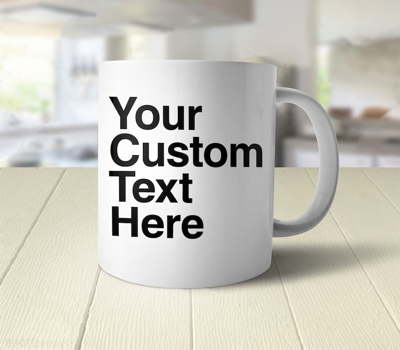 May include: White ceramic coffee mug with black text that reads "Your Custom Text Here".