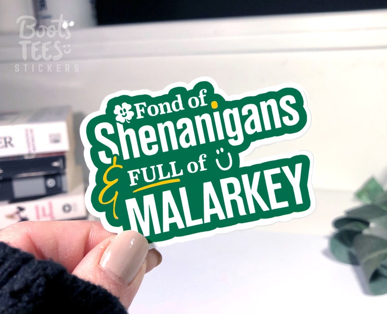 Puede incluir: Pegatina verde y blanca con el texto "Fond of Shenanigans & FULL of MALARKEY" con un tr&eacute;bol y una carita sonriente.