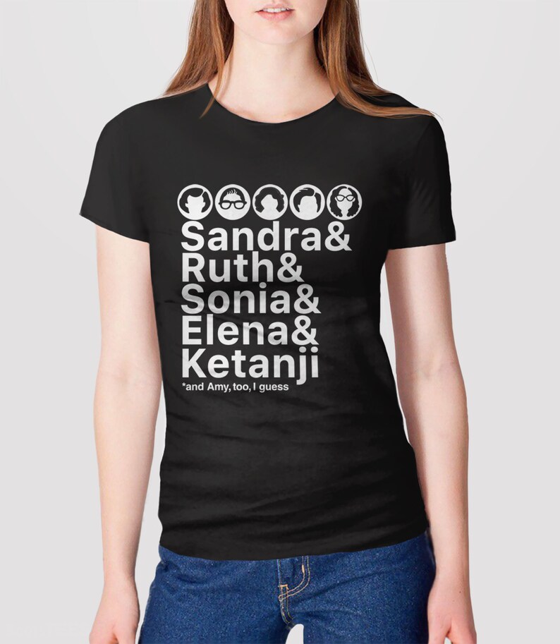 May include: Black t-shirt with white text and illustrations of five women. The text reads "Sandra & Ruth & Sonia & Elena & Ketanji *and Amy, too, I guess".