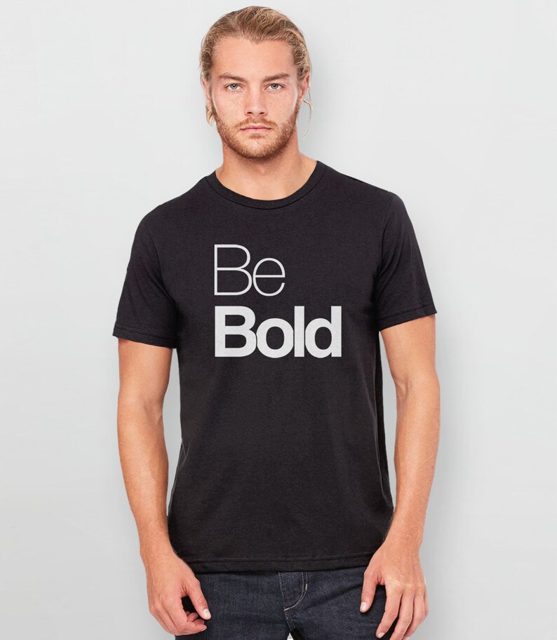 May include: A black t-shirt with the words "Be Bold" printed in white on the front.