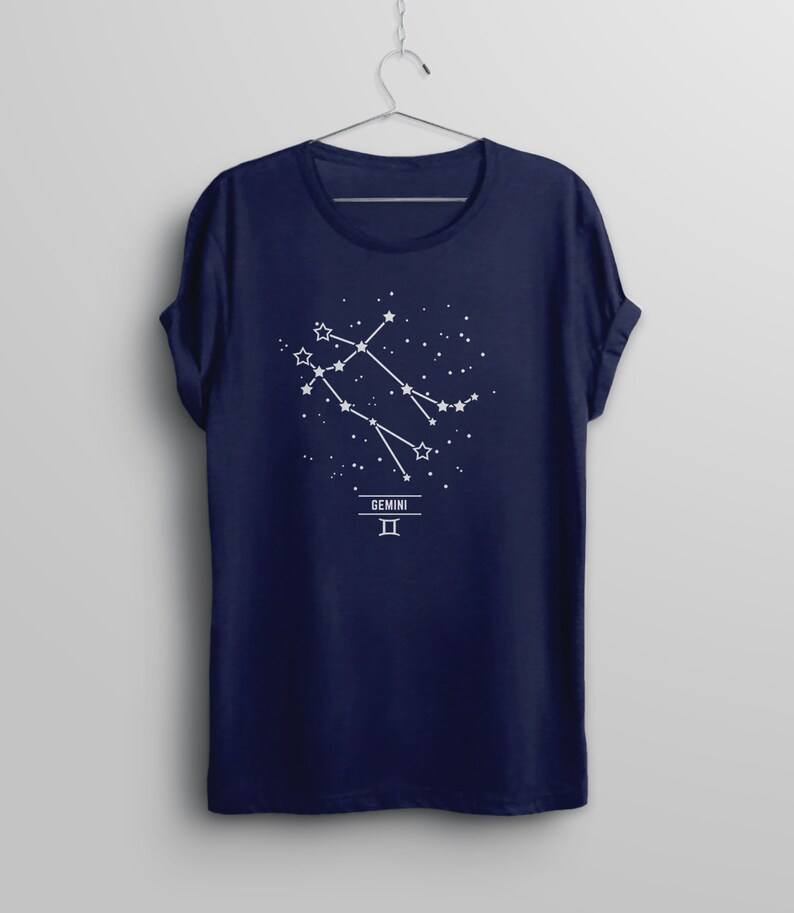 May include: Navy blue t-shirt with a white graphic of the Gemini constellation and the text "GEMINI II".