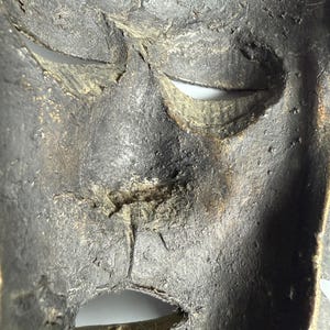 Macro inside view bronze African mask texture patina authentic sculpture