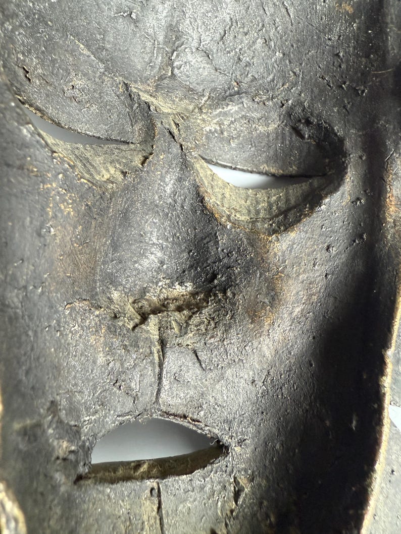 Macro inside view bronze African mask texture patina authentic sculpture