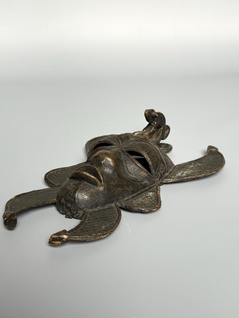 Low angle African bronze mask vintage tribal home decor handmade