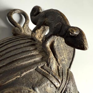 Bronze lizard detail on top of African tribal mask lost-wax cast