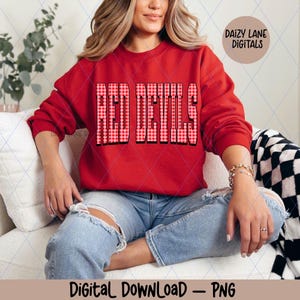 May include: A red sweatshirt with the text "RED DEVILS" in a bold, checkered pattern. The sweatshirt is part of a digital download, as indicated by the text at the bottom of the image. The brand name "DAIZY LANE DIGITALS" is also visible.