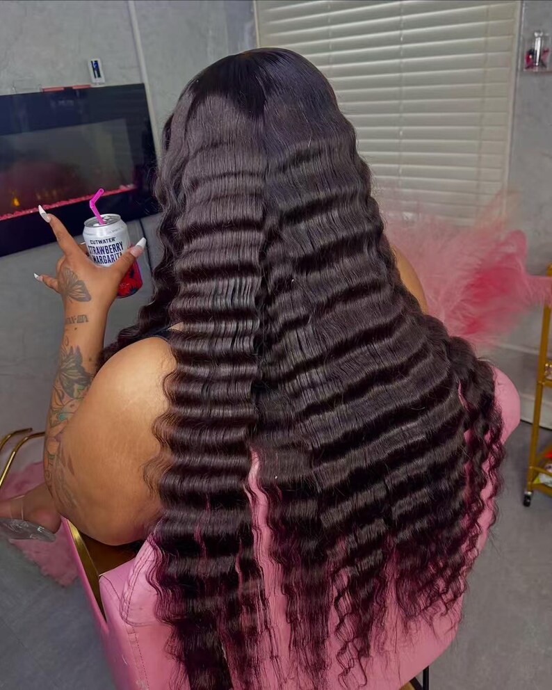 May include: Long, dark brown crimped hair with a reddish-purple ombre effect. The hair cascades down the back. A can of Strawberry Margarita is held in the hand.