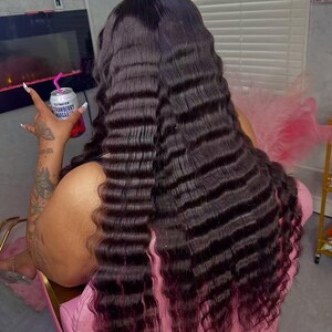 May include: Long, dark brown crimped hair with a reddish-purple ombre effect. The hair is styled in a wavy pattern. A can of Strawberry Margarita is held in the hand.