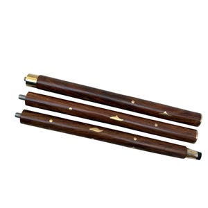 May include: Three-piece wooden walking cane with a dark brown finish. The cane features brass accents and metal screw threads for assembly. The top and bottom sections have brass-colored metal bands.