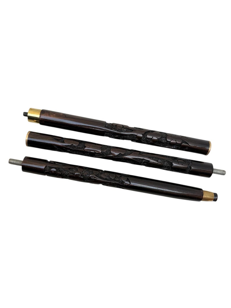 May include: Three dark brown wooden walking cane sections with carved floral designs. Each section has a brass-colored metal band at one end. One end of each section has a threaded metal tip.