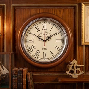 May include: A round wall clock with a dark wood frame and a silver metal bezel. The off-white face features black Roman numerals, ornate black hands, a thin red second hand, and the text Colonial Clock Co. estd. 1937 printed in black.