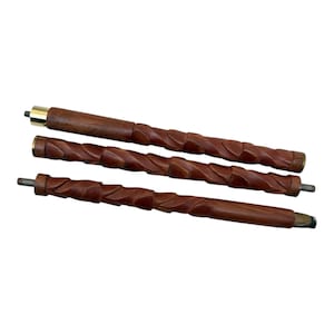 May include: Three-piece wooden walking cane with a dark brown finish. The cane is carved with a spiral design and features brass accents on the top and bottom. The pieces are disassembled, showing the threaded ends for assembly.