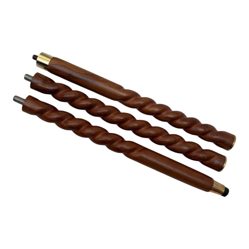 May include: Three wooden walking cane shafts with a spiral design. The shafts are a dark brown color with brass-colored metal accents on the ends. The shafts have a threaded end for attachment.