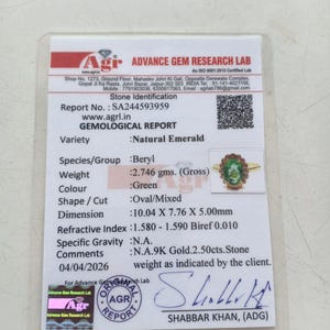 May include: A gemological report detailing a natural emerald, with specifications such as weight, colour, and dimensions. The report is from Advance Gem Research Lab. The emerald ring's dimensions are 1.00cm x 0.78cm x 0.50cm. The report includes a photo of the ring.