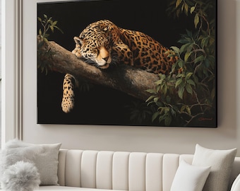May include: A framed canvas print depicts a resting jaguar on a tree branch. The jaguar has a spotted coat and is lying on a brown branch with green leaves. The background is black, creating a contrast with the animal.