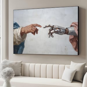 May include: A framed art print showing a modern take on Michelangelo's 'The Creation of Adam'. The artwork replaces Adam's hand with a metallic robotic hand, with both hands almost touching. The background is a textured, off-white wall.