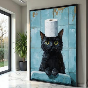 May include: A framed canvas art print featuring a black cat with yellow eyes, wearing a roll of toilet paper as a hat. The cat is set against a blue tiled background with gold accents. The artwork is displayed in a modern interior setting.