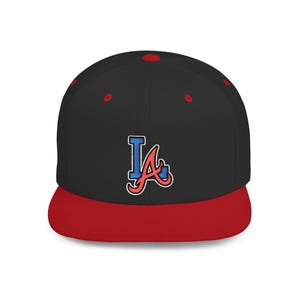 May include: Black and red baseball cap with a flat brim. The cap features an embroidered logo in blue and red. The crown is black, and the brim is red. The cap has a snapback closure.