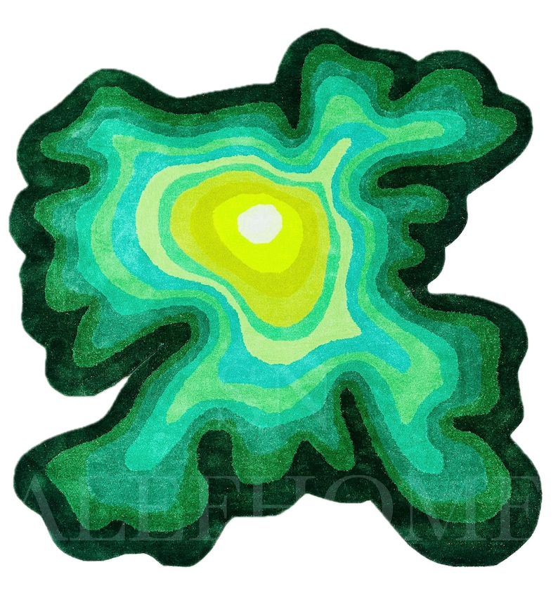 May include: A vibrant, abstract rug with a layered design resembling a topographical map. The rug features concentric rings of varying shades of green, turquoise, and yellow, creating a visually striking and organic pattern. The rug is a unique home decor item.