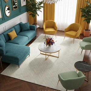 May include: A teal sectional sofa with a yellow pillow sits in a room with yellow curtains and a chandelier. The room features a white rug, gold-framed mirrors, and several accent chairs in yellow and green. The floor is dark wood.