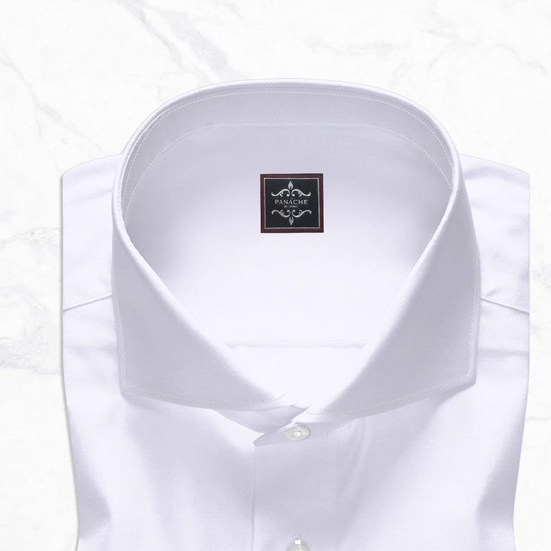 White cutaway collar dress shirt made from 100% Giza cotton poplin with French square cuffs, smooth back, no pocket, collar stays, 3-inch collar wings, and 1.5-inch collar band.