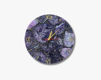 May include: Circular wall clock with a purple and blue agate stone pattern. The clock face has gold Roman numerals and gold hands with a red second hand. A decorative home decor item.