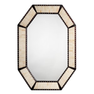 May include: An octagonal mirror with a dark brown frame. The frame is accented with light-colored, vertical rectangular pieces and small, evenly spaced, dark dots. The mirror's shape is geometric and modern, suitable for home decor.