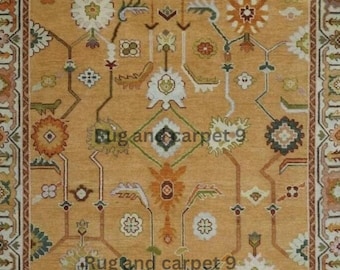 May include: Mustard-colored area rug with an intricate floral and geometric pattern. The rug features a central design with repeating floral motifs in white, orange, and green, framed by a detailed border. The text "Rug and carpet 9" is visible on the rug.