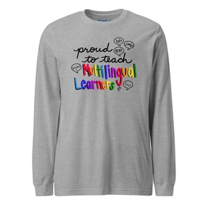 May include: A long-sleeve gray shirt with the text "proud to teach Multilingual Learners" in colorful lettering. Speech bubbles with greetings in different languages surround the text, including "hola", "jambo", and "bonjour".