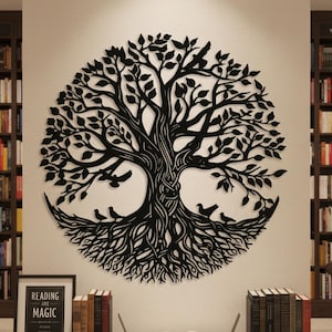 May include: Black metal tree of life wall art with birds and roots. The tree is circular and mounted on a white wall. A framed print with the words "Reading are Magic" is on a table below the art.