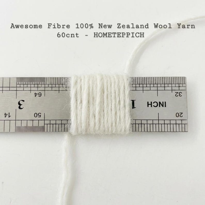 May include: A close-up of a bundle of white yarn, measured with a ruler. The ruler shows measurements in inches. Text at the top reads "Awesome Fibre 100% New Zealand Wool Yarn 60cnt - HOMETEPPICH."
