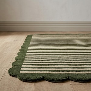 May include: A rectangular rug featuring a pattern of thin, alternating dark olive green and cream-coloured horizontal stripes. The rug is finished with a decorative scalloped edge border in a solid dark olive green, creating a soft, rounded outline.