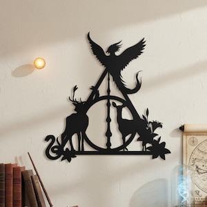 May include: Black metal wall art featuring a stylized phoenix, deer, and snake within a triangle and circle design. The artwork includes floral accents and is mounted on a white wall. A decorative piece for home decor.