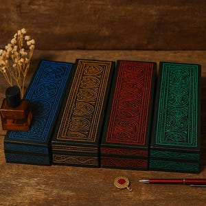 May include: Four rectangular wooden boxes with ornate, colorful designs. The boxes are black with blue, gold, red, and green patterns. A small perfume bottle and a pen are also visible.