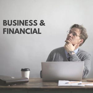 May include: A man wearing glasses and a gray sweater is deep in thought, with his hand on his chin. A laptop, coffee cup, and briefcase sit on a wooden desk. The words "BUSINESS & FINANCIAL" are displayed on the wall.
