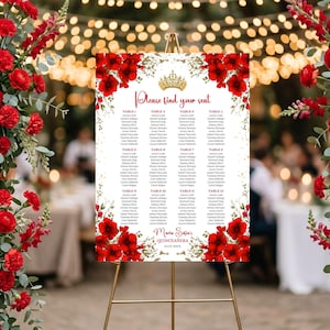 May include: A white seating chart with red floral accents and gold text, displayed on a gold easel. The chart reads "Please find your seat" and lists guest names by table. The event is a quinceañera.