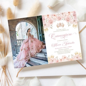 May include: A Quinceañera invitation card with a photograph of a young woman in a pink dress, adorned with floral and crown motifs. The invitation includes the text "Quinceañera" and the name "Anna Gabriella". The invitation is in an envelope.