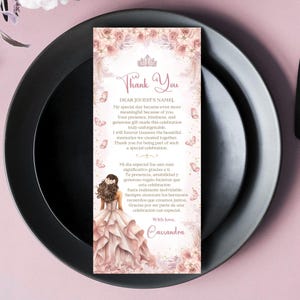 May include: A thank you card with a floral and butterfly design, featuring a crown and the words "Thank You." The card includes text in English and Spanish, with a watercolor illustration of a woman in a pink dress.