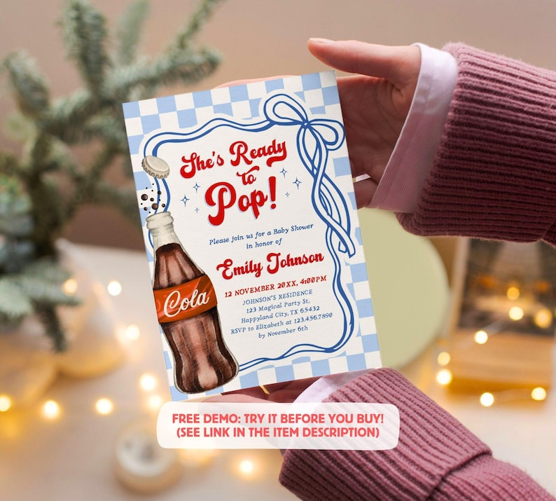 Puede incluir: Invitaci&oacute;n para baby shower con una ilustraci&oacute;n de botella de refresco vintage. La invitaci&oacute;n presenta el texto "She's Ready to Pop!" en rojo y azul, con detalles del evento y una solicitud de confirmaci&oacute;n.