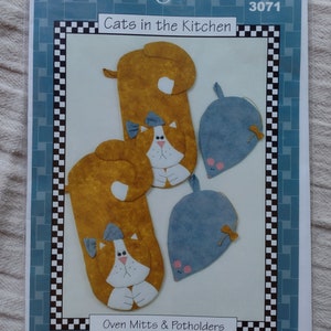May include: A craft pattern for making oven mitts and potholders. The pattern features two cat oven mitts and two mouse potholders. The pattern is titled "Cats in the Kitchen" and is from L.A. Designs. The pattern number is 3071.