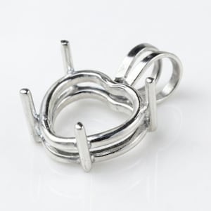 May include: A silver-colored heart-shaped pendant setting with four prongs and a loop for a chain. The setting is made of metal and has a polished finish. The design is simple and elegant, suitable for a gemstone.