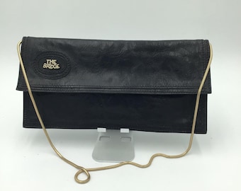 The Bridge women's clutch bag in black full grain leather, vintage from 1970, made in Italy, perfect for an elegant casual look.