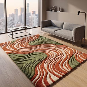 Pode incluir: Um tapete retangular com textura de pelo alto e baixo, apresentando um padrão ondulado e rodopiante em tons de laranja queimado, verde sálvia e creme. O design consiste em linhas fluidas em relevo que criam um efeito tridimensional.