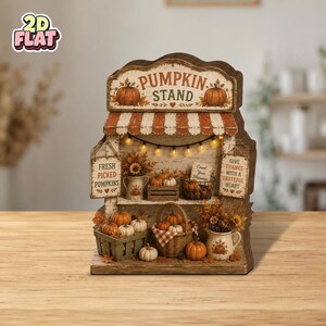 Puede incluir: Un letrero decorativo de madera de puesto de calabazas con toldo a rayas, luces y estantes llenos de calabazas en miniatura, cestas y arreglos florales. El letrero muestra el texto PUMPKIN STAND, FRESH PICKED PUMPKINS, COUNT YOUR BLESSINGS y GIVE THANKS WITH A GRATEFUL HEART.