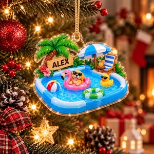 Könnte beinhalten: Ein transparenter Acryl-Weihnachtsbaumschmuck mit einer Pool-Szene, einem goldenen Welpen in einem rosa Flamingo-Schwimmring, einer gelben Quietscheente, einem Strandball, einem grünen Schwimmring, einem blau-weißen Sonnenschirm und einem Schild mit dem Namen ALEX.