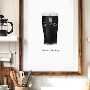 May include: Framed print featuring a pint of Guinness stout. The black beer is topped with a creamy white head, with the Guinness logo visible. The text "...Guinness is Good for you..." is below the pint. The frame is a dark brown color.