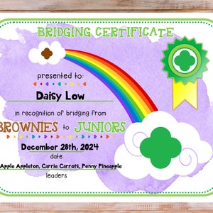 May include: A purple and green certificate with a rainbow and clouds. It says "Bridging Certificate" and is presented to Daisy Low in recognition of bridging from Brownies to Juniors on December 28th, 2024. The certificate is signed by Apple Appleton, Carrie Carrots, and Penny Pineapple.