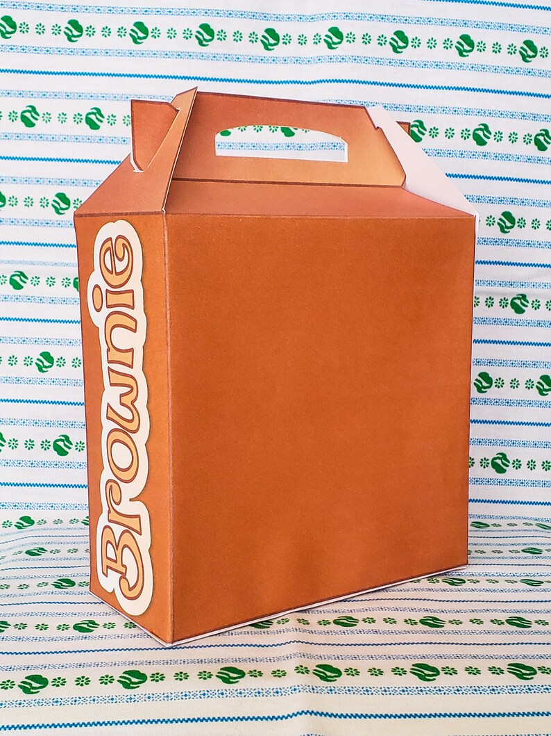 May include: A brown cardboard box with a handle and the word "Brownie" printed on the side.